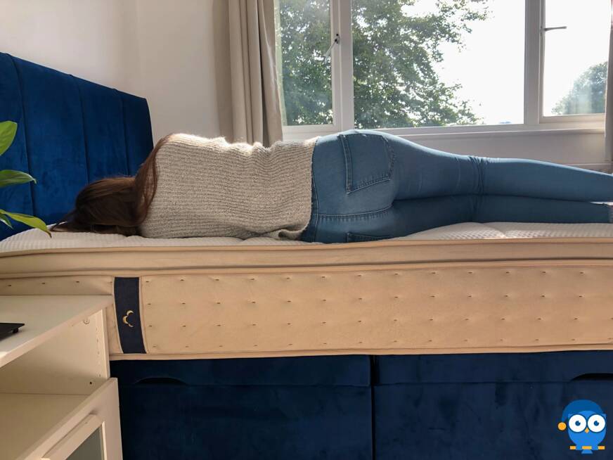 Person laying on side on DreamCloud mattress.